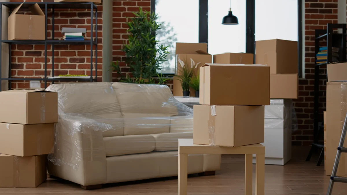 Packed living room with furniture and moving boxes ready for professional haul away furniture service