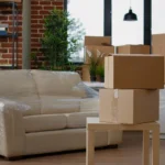 Packed living room with furniture and moving boxes ready for professional haul away furniture service